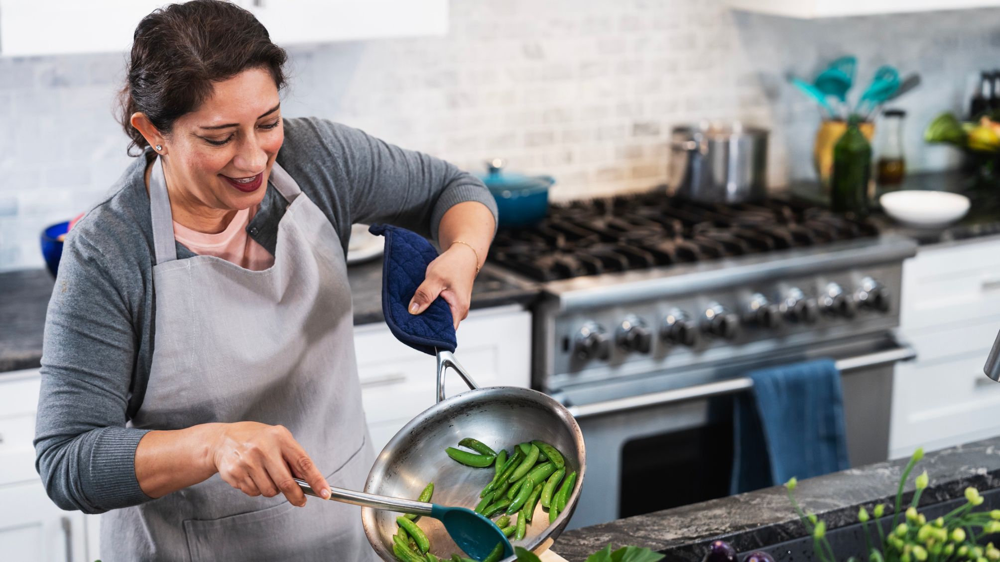 A woman enjoying cooking at home.