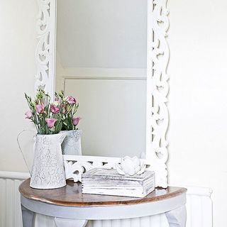 hall room with white walls and flowers in white vase