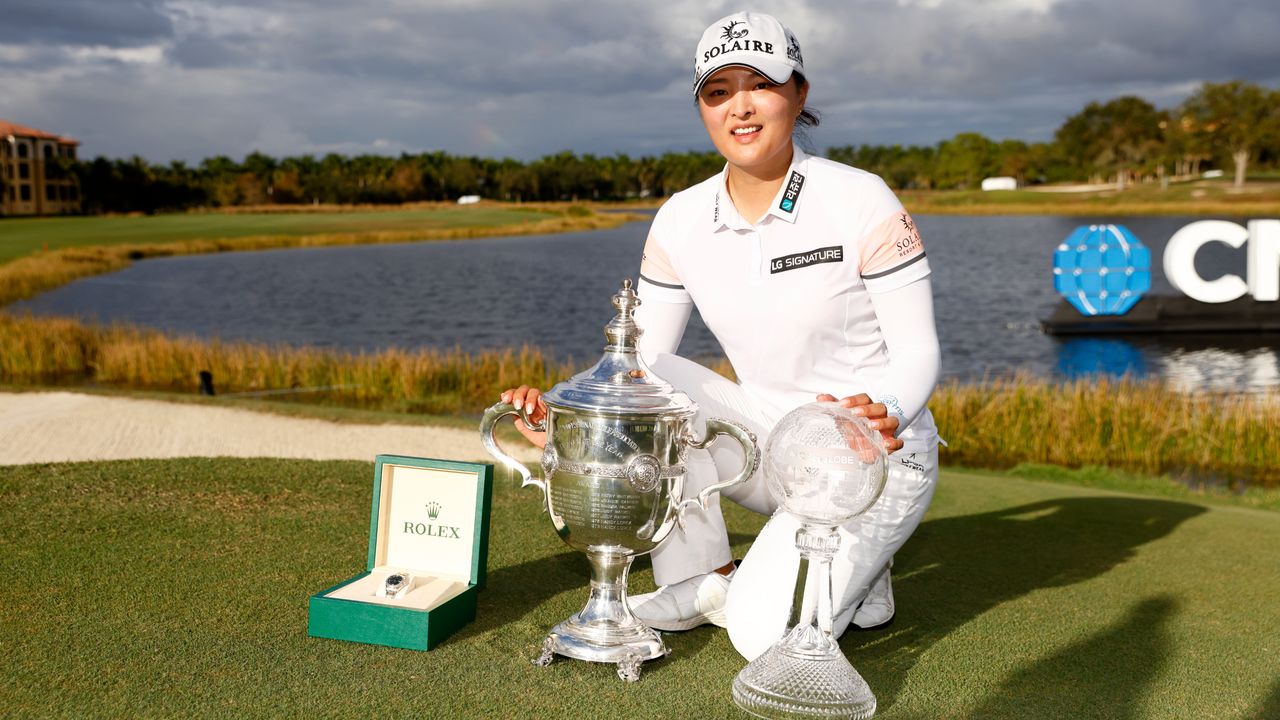 Jin Young Ko with the Rolex Player of the Year trophy and CME Globe trophy after winning the 2021 CME Group Tour Championship