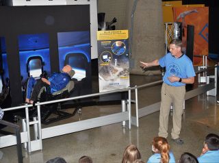 Blue Origin CrewMember 7 and chief trainer Kevin Sprogue talks at the unveiling of the Mannequin Skywalker exhibit at the U.S. Space & Rocket Center in Huntsville, Alabama.