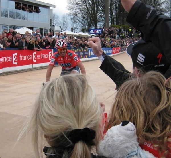 Fabian Cancellara (Saxo Bank) spots his wife and daughter in the crowd as he makes his way around the Roubaix velodrome
