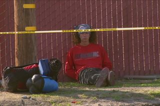 Kai Lawrence aka the hatchet wielding hitchhiker sat behind police tape