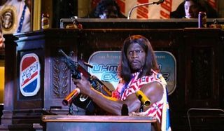 Idiocracy President Camacho makes a speech, automatic weapon in hands