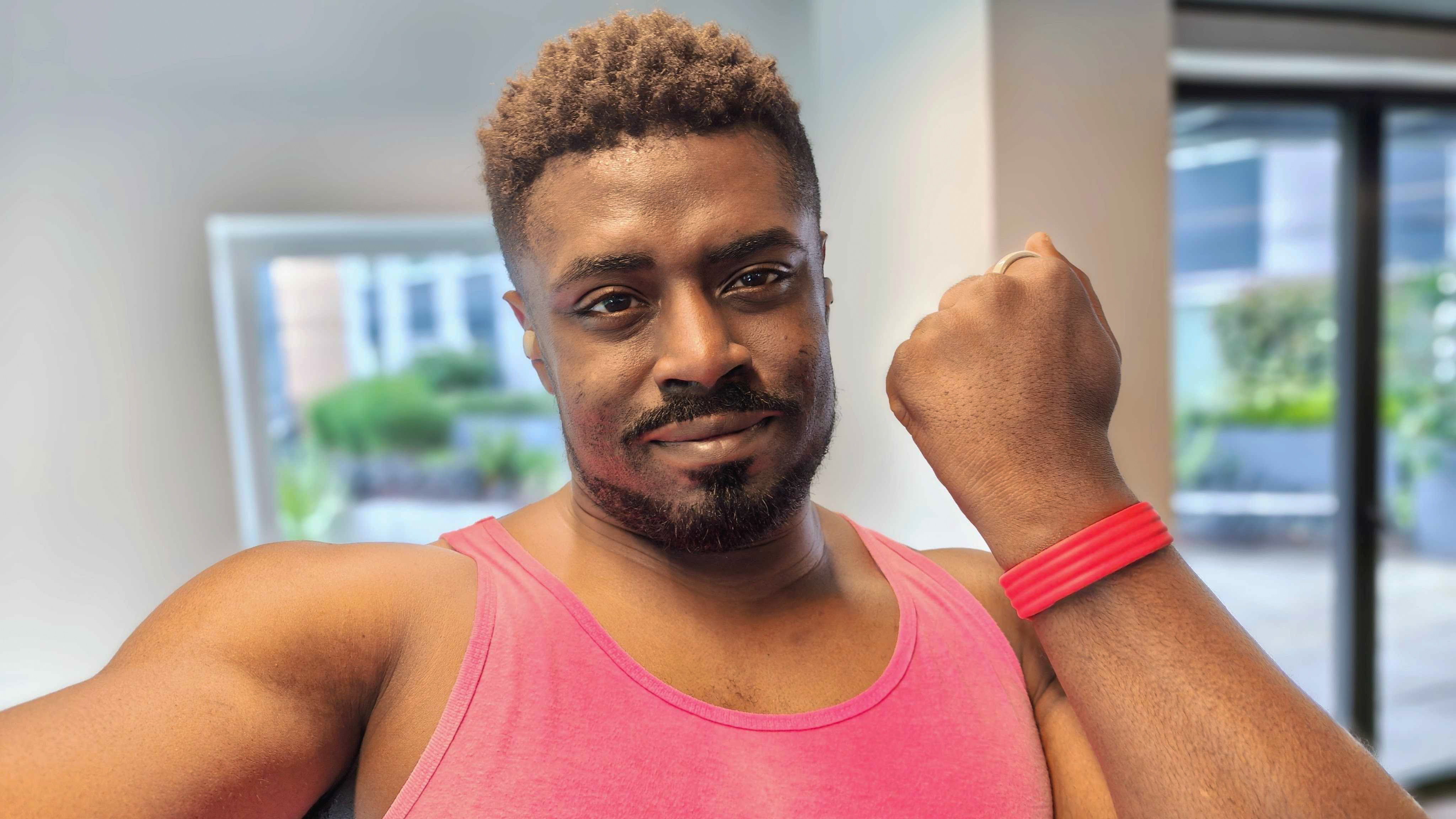 A man holding his arm up with the Fitbit Air wrapped around his wrist