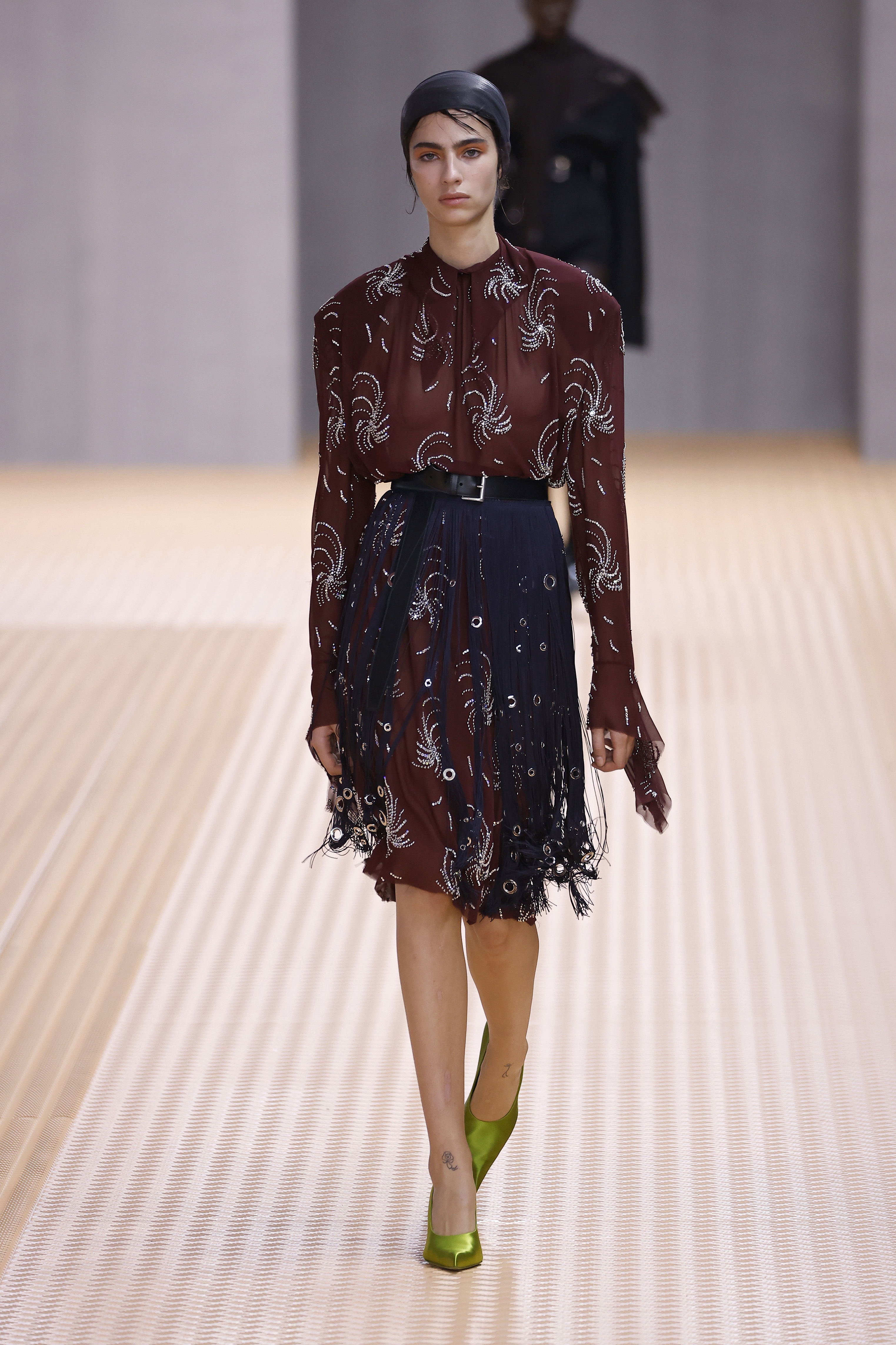 Prada runway image wearing power dressing dress
