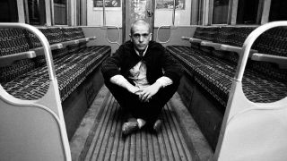 Peter Gabriel sitting on a London Underground train
