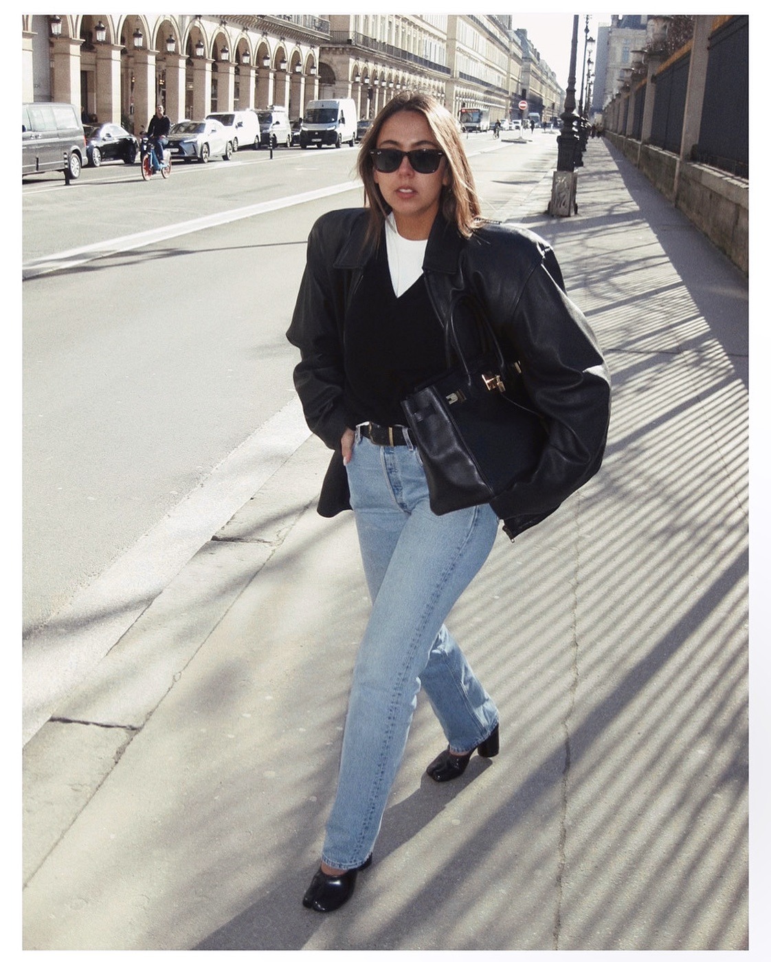 Hanna Marzouki Widlund wearing jeans with a sweater, white T-shirt, and jacket.