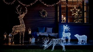Porch illuminated at nighttime by layered lights used as outdoor christmas decorating idea
