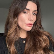 A selfie of Eleanor wearing Chanel makeup and a black cardigan