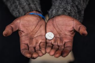 Hands holding a coin.