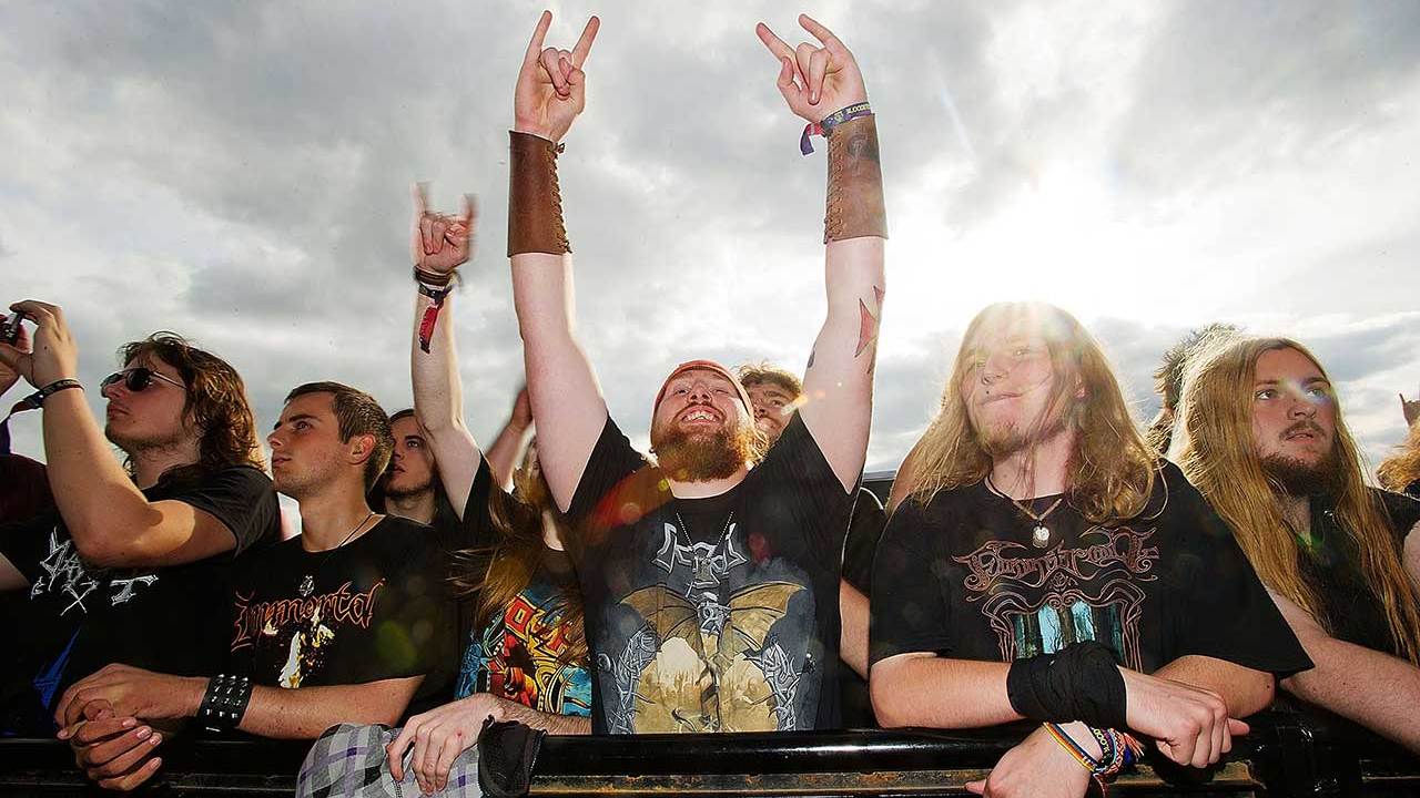 Metal fan throwing the horns at Bloodstock festival