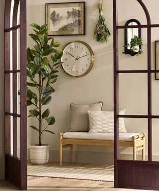 Entryway with bench, pictures and potted plant