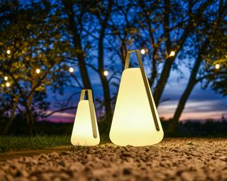 Modern LED lanterns lit at night in a garden