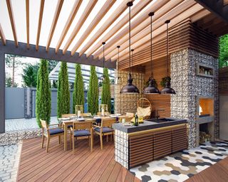 outdoor kitchen with pergola and modern pendant lights