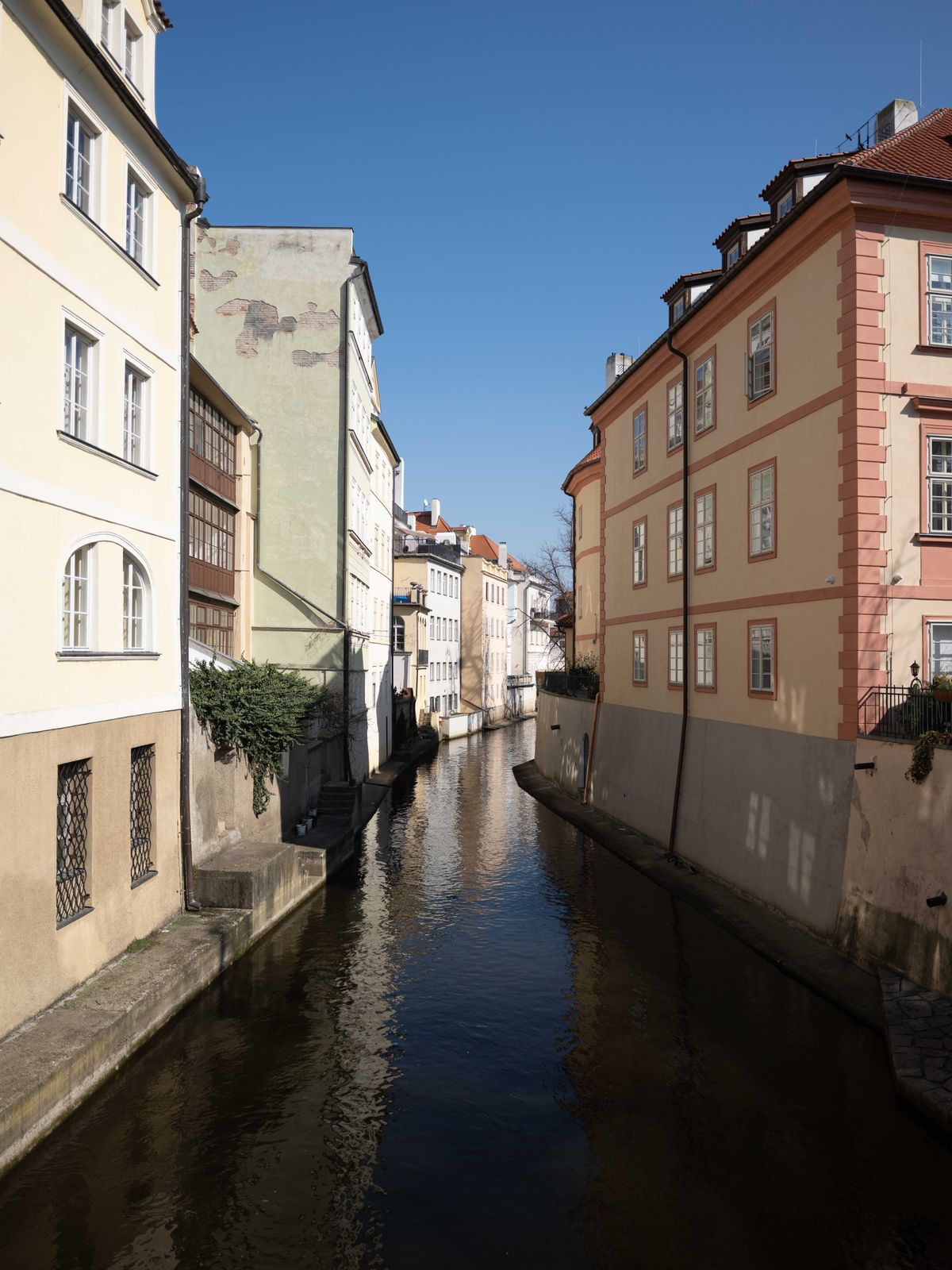 River in Prague flowing between buildings