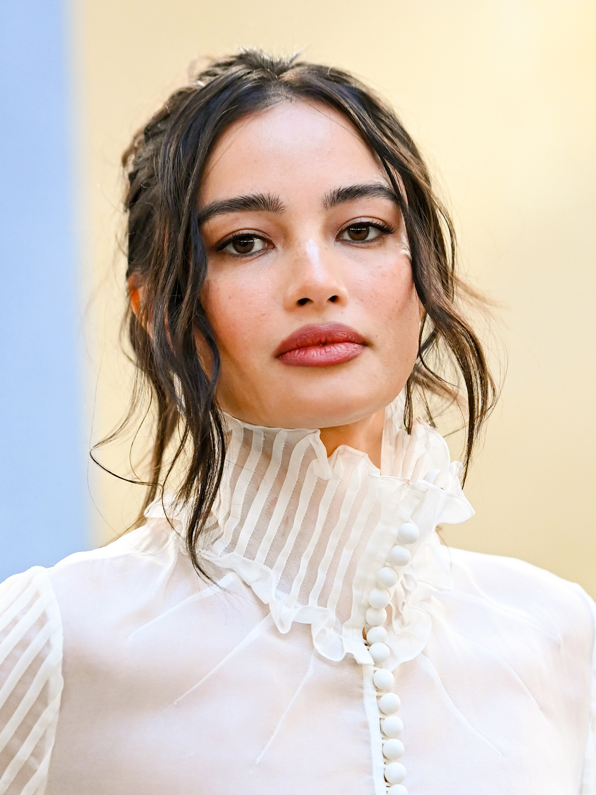 Kelsey Merritt at the Carolina Herrera fashion show as part of RTW Fall 2026 with a romantic updo and face-framing strands