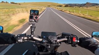 Insta360 Ace Pro 2 camera on a motorcycle with the screen flipped up facing the driver's POV