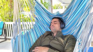 Our reviewer testing the Treblab Z7 Pro's active noise cancelling in a backyard
