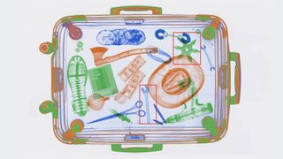 X-ray of a suitcase packed with items including Polaroid film 