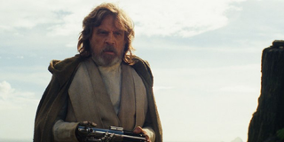 Luke Skywalker holds lightsaber in Star Wars: The Last Jedi