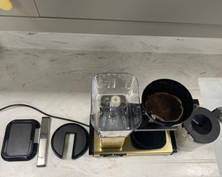 A Technivorm Moccamaster Select on deconstructed on marble kitchen countertop