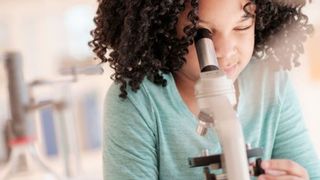 A child using one of the best microscopes for kids