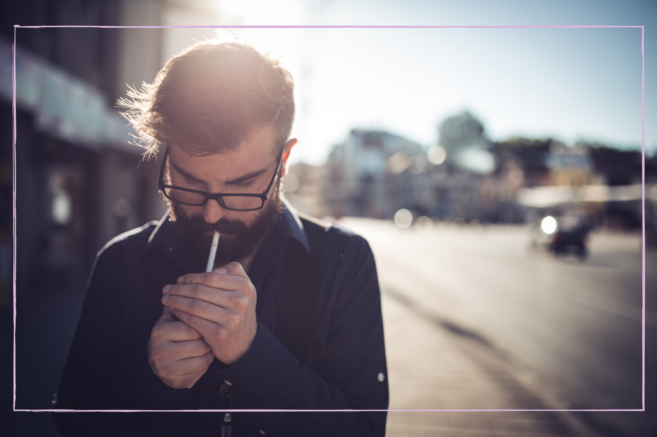 Man holding hands around a lighter on a cigarette