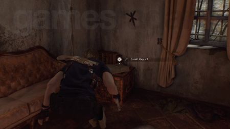 Resident Evil 4 small key being collected by Leon