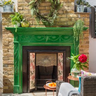 garden with green fireplace and wreath