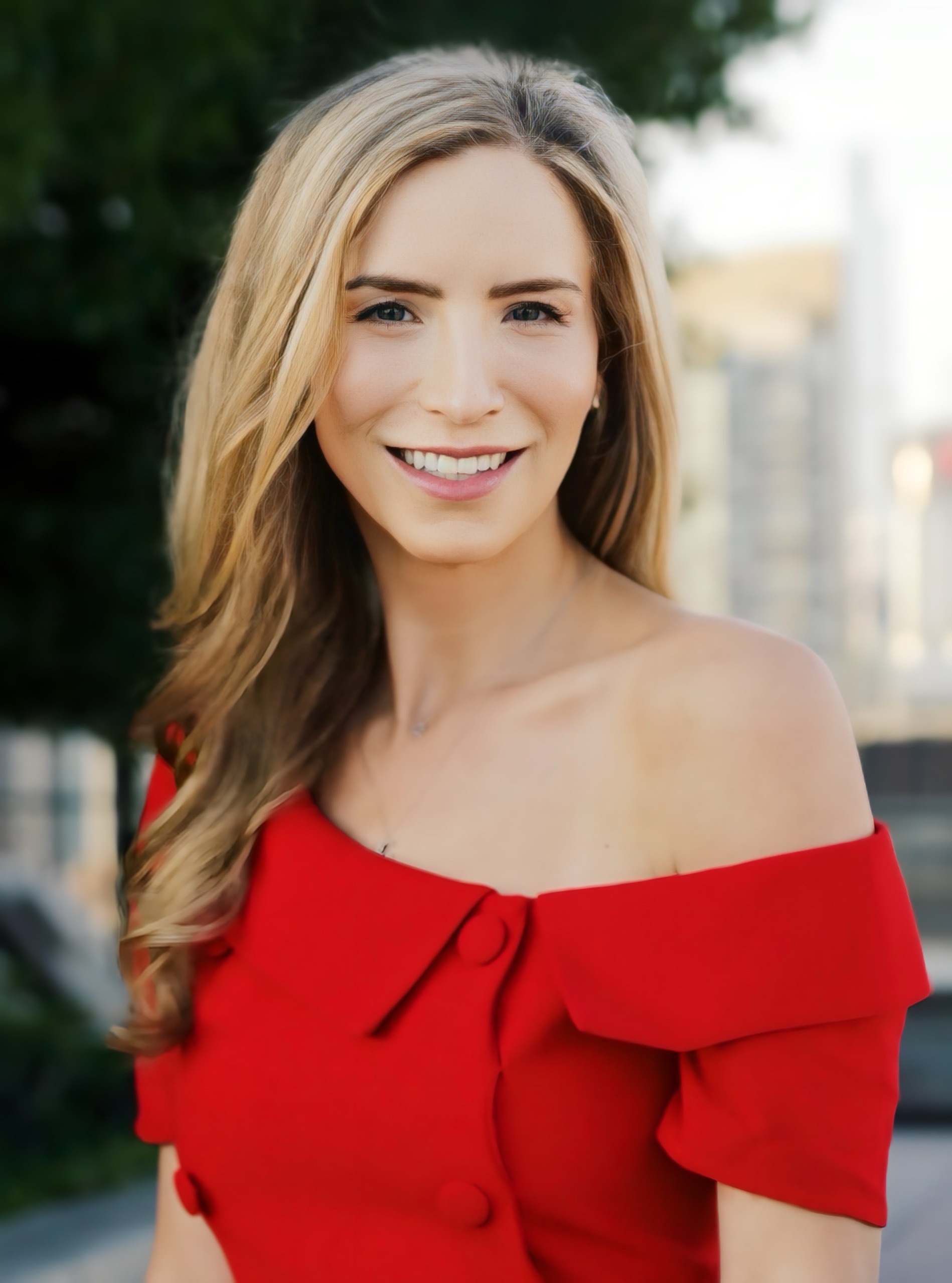 a white woman with long blonde hair in a red shirt