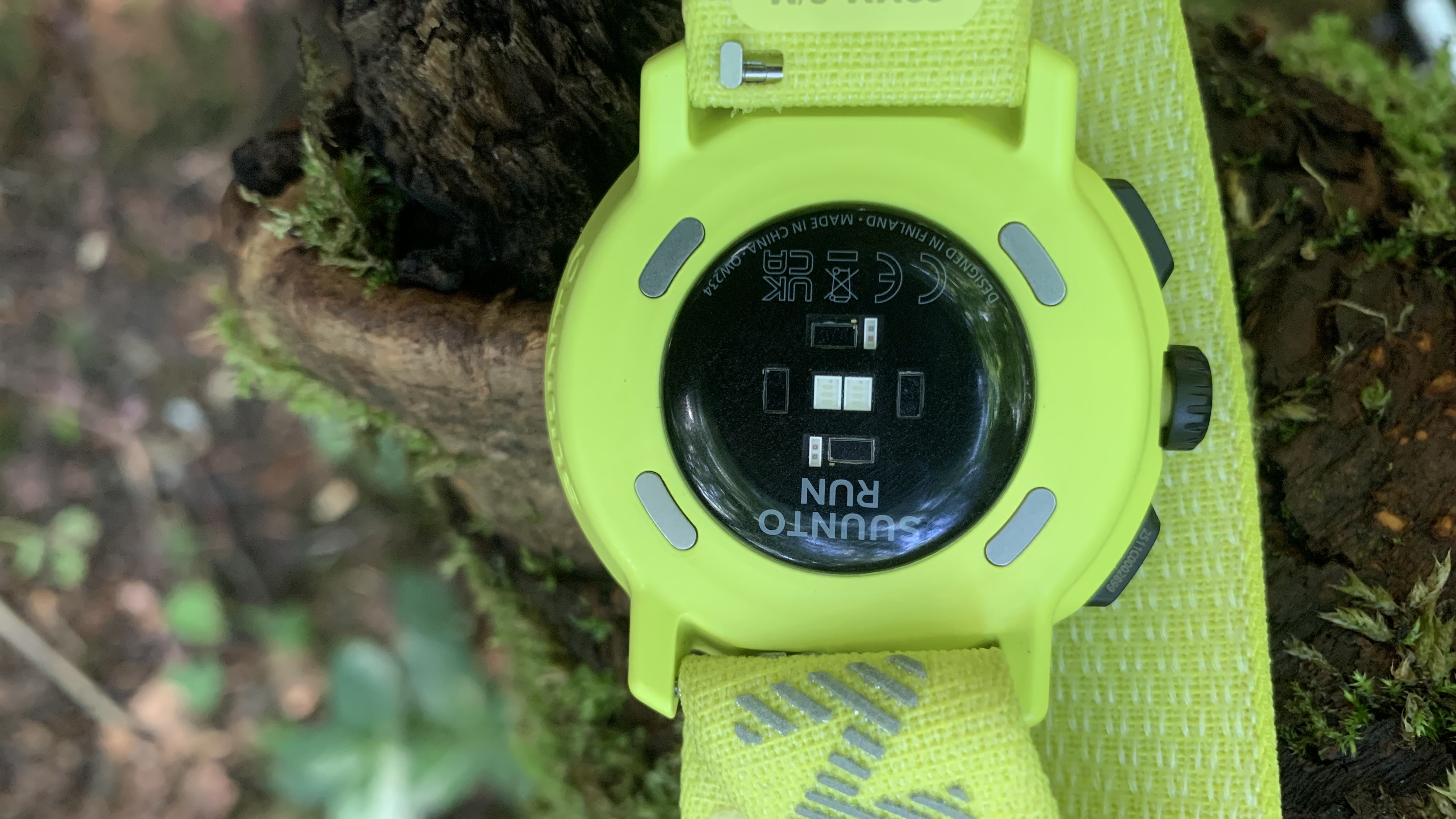 The heart rate monitor on the back of the yellow Suunto Run watch