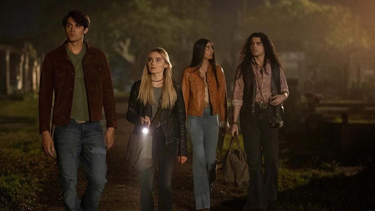 The cast of The Winchesters season 1 with flashlights roaming in the dark