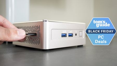 The Geekom A5 mini PC on a desk with a Tom's Guide Black Friday deals badge