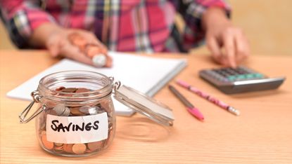 Man counting pennies for savings jar