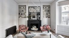 Black and white living room with red patterned chairs
