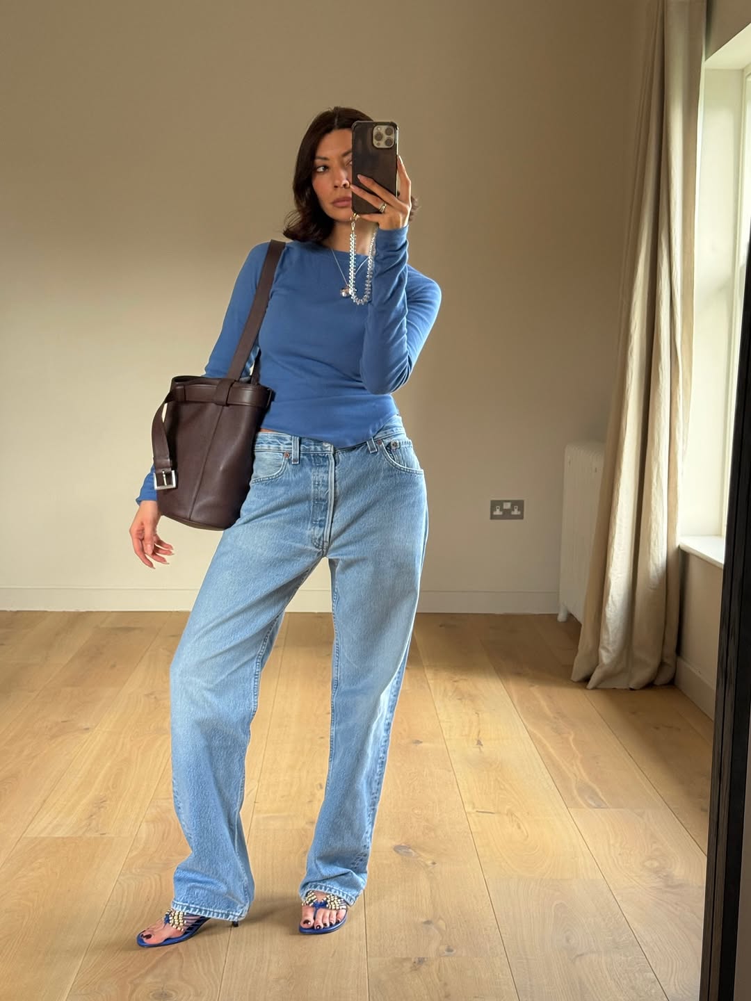 woman wearing heels with jeans spring outfit 2026