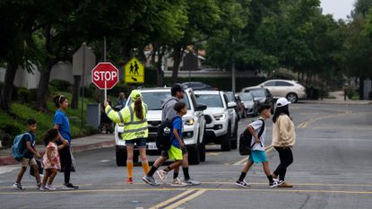 Students walk with their parents on the first day of school in Rancho Santa Margarita, California.