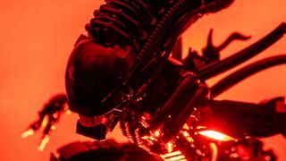 A Lego Xenomorph kit seen up close, against a glowing red background