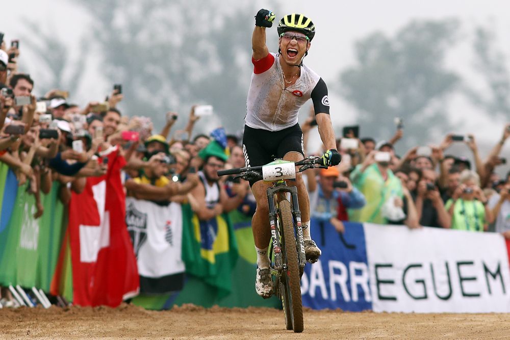 Nino Schurter celebrates his Olympic gold medal