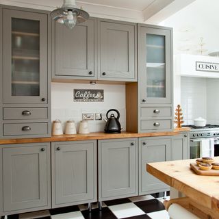 kitchen room with cabinets and wooden worktop with tea pot