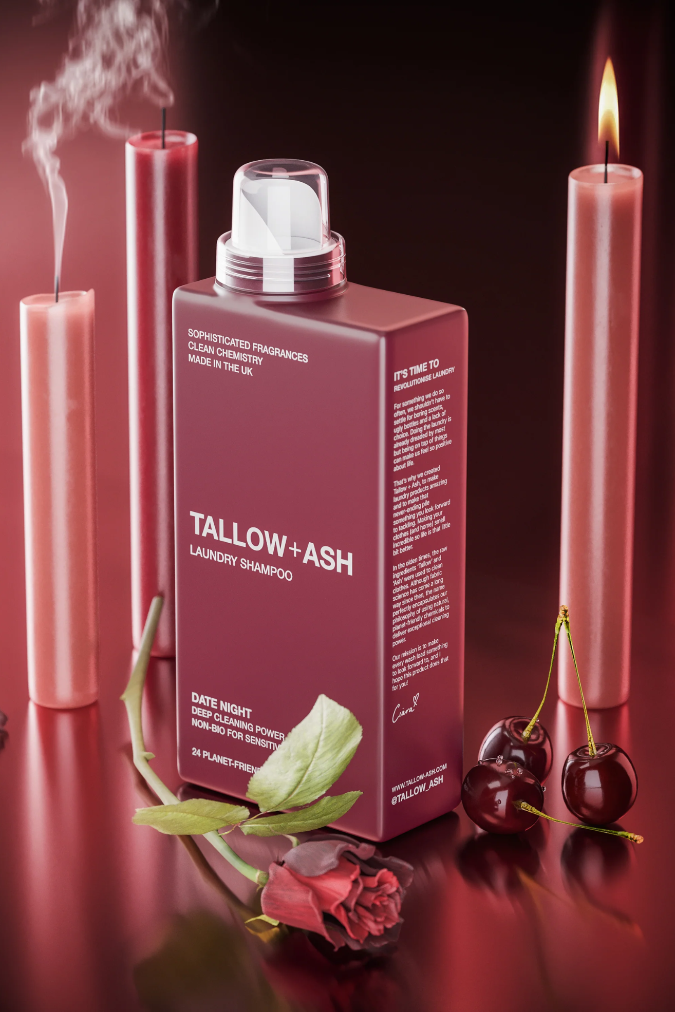 A burgundy bottle of laundry liquid by some candles, a rose, and some cherries