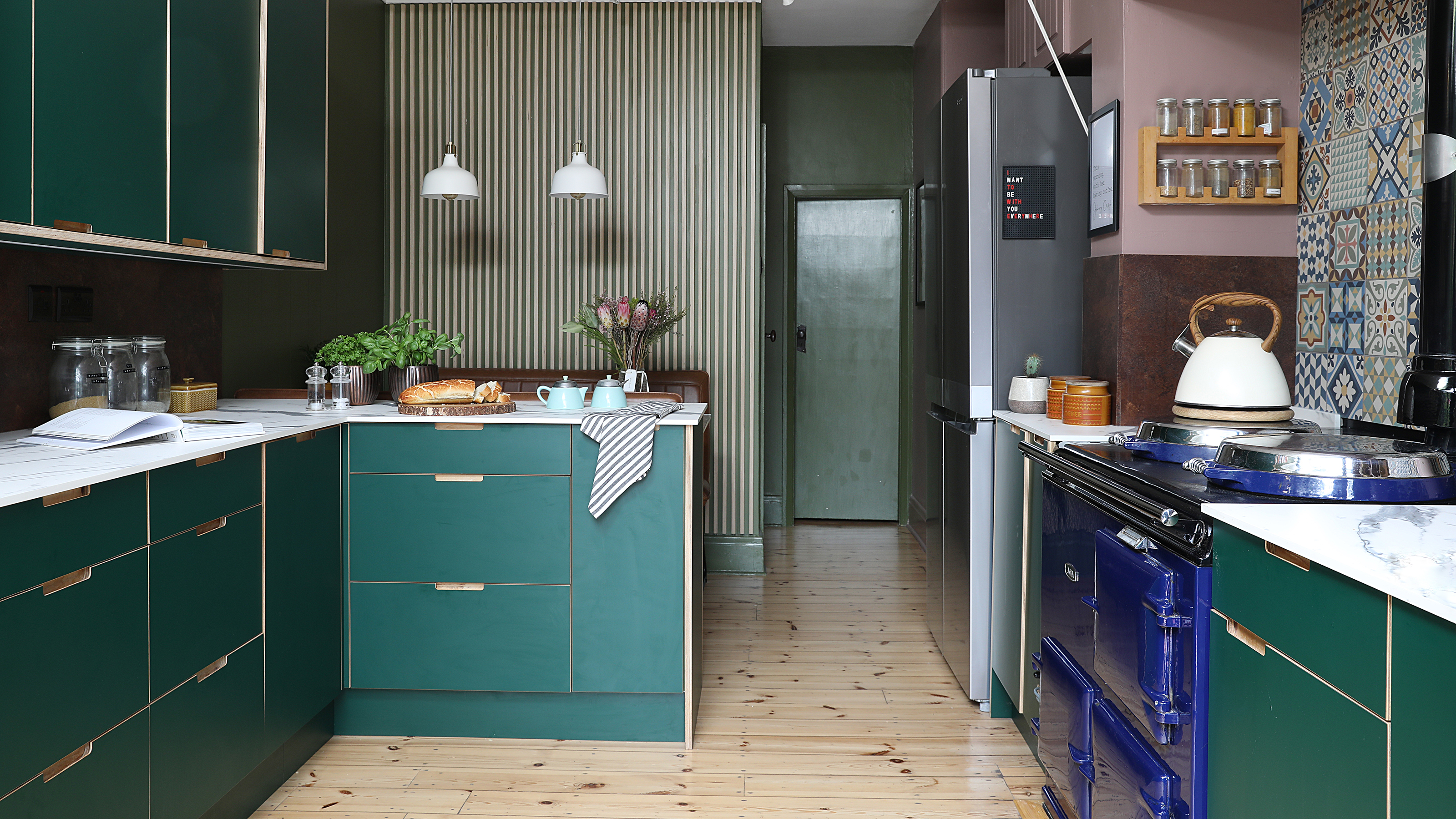 Green slab kitchen with wall panelling 