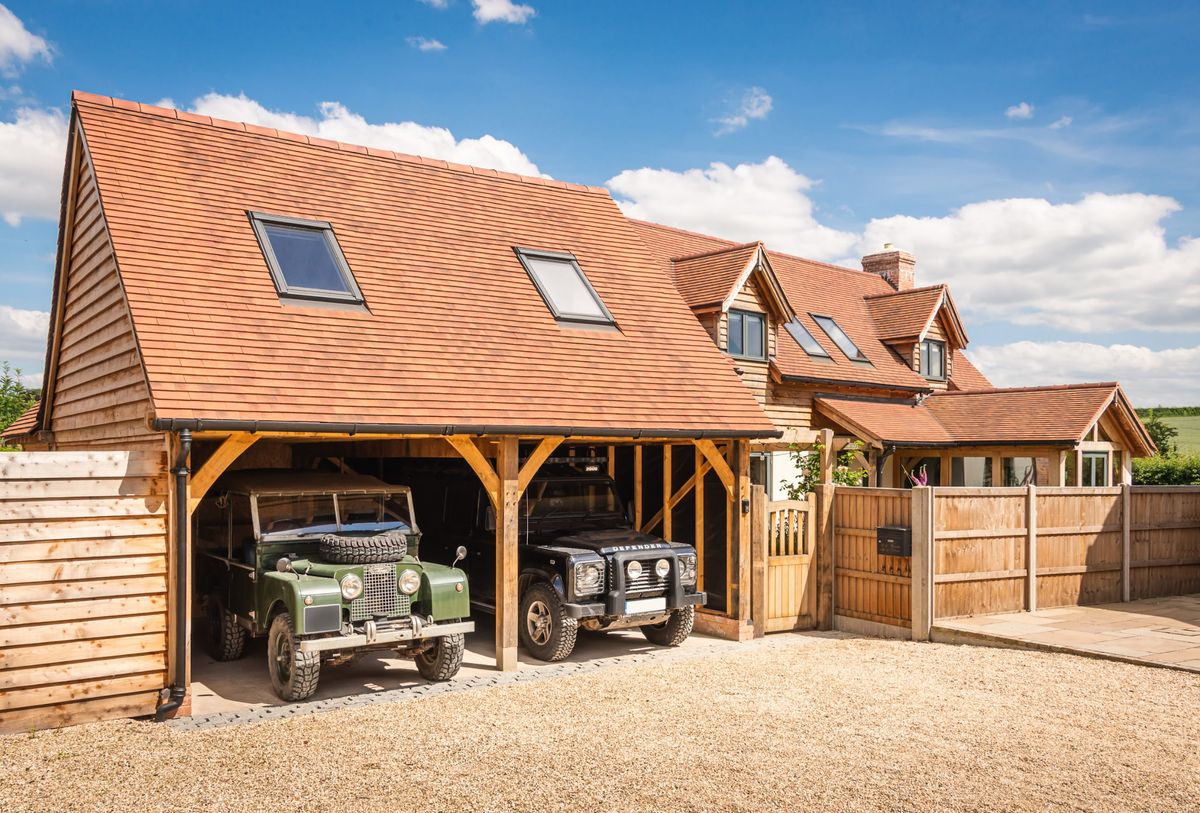 A double garage with two parked landrovers