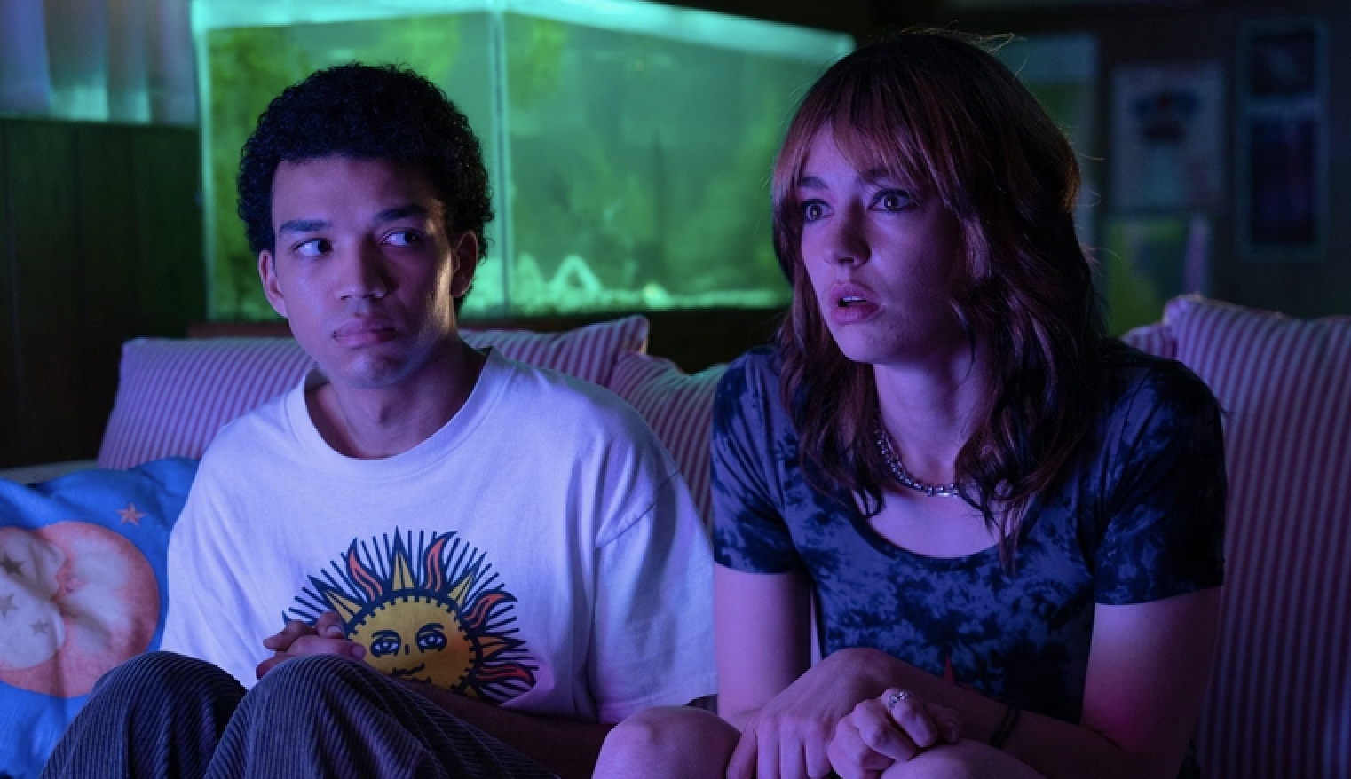 Judge Smith and Brigette Lundy-Paine sit in front of a television