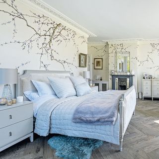 big double bedroom with wallpaper with branches pattern