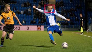 Bristol Rovers soccer player is about to kick the ball, red rectangle represents AF point