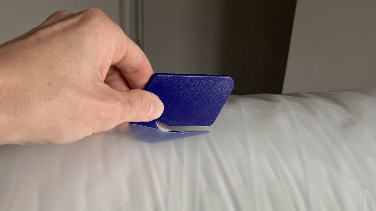 Plastic being cut open on Lola Cool Hybrid mattress