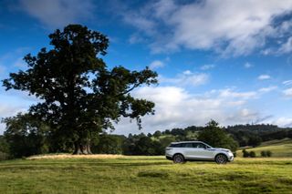Range Rover driving across fields