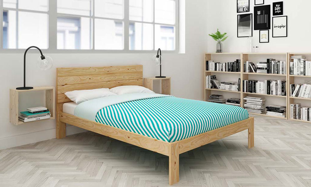 bedroom with book shelves and bed with pillows