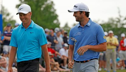 Hardy and Riley smile together as they walk off the 18th green